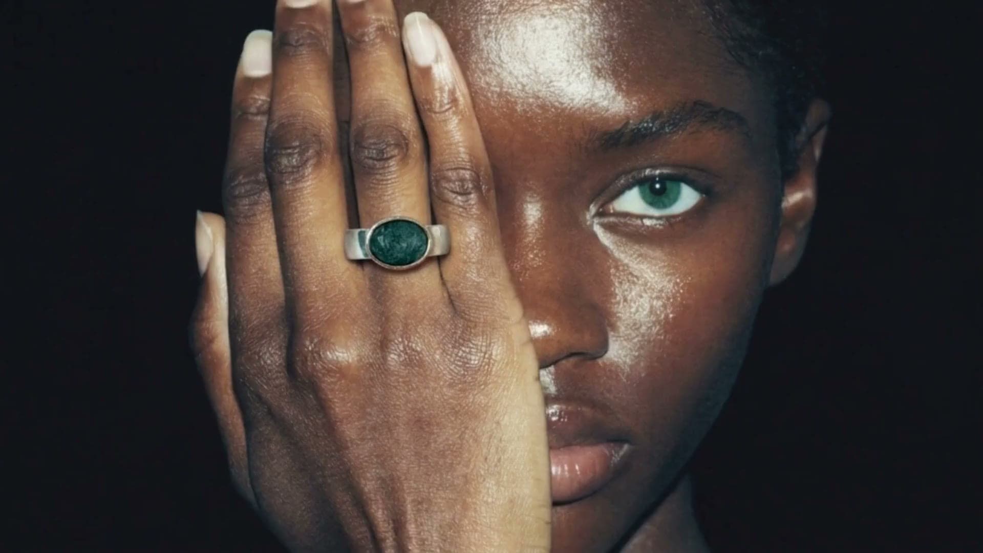 Scenes from the studio's work: a ring, a portal in the Alps, a serum by the water, a black dress on a street, a green heel, a candle in a magazine, a lamp in a dark room